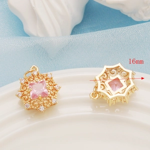 Detailed view of 16mm gold flower pendant with pink gemstone and zircon settings