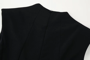 Detailed view of the sewing structure and stitching on a black sleeveless long dress