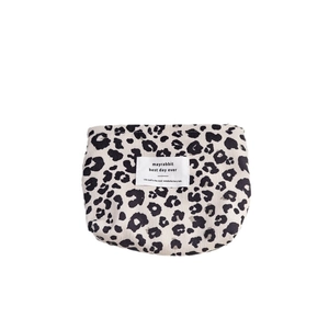 Portable leopard print corduroy makeup bag with zippered closure and minimalist branding