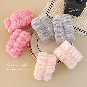 Three plush flannel wrist washbands in pink and grey for face washing and skincare