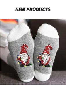 Detailed knit texture of mid-calf socks with festive Christmas gnome and lights design