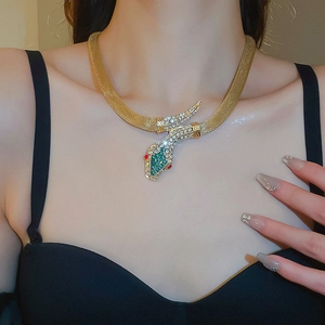 Close-up of a vintage gold snake necklace with crystals on a model's neck