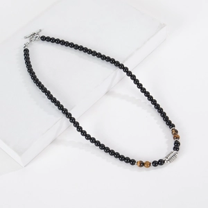 Detail of 6mm tiger eye and obsidian beaded necklace with a metal toggle clasp