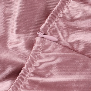 Close-up of a pink satin dress showing the fine fabric texture and invisible zipper detail