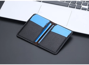 Detail of slim black lychee grain leather card holder with multiple card slots and fine stitching