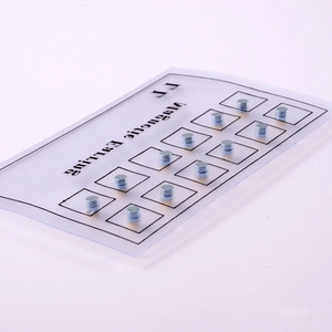 Macro view of 12 pairs of magnetic silver ball stud earrings on a display card