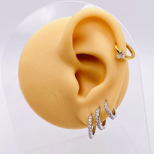 Sweet heart gold earring and silver CZ hoop set shown on a silicone model ear