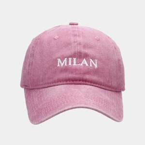 Close-up of MILAN white embroidery on vintage washed pink cotton baseball cap