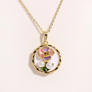 Close-up of oil painting style flower pendant with natural pearls and golden frame