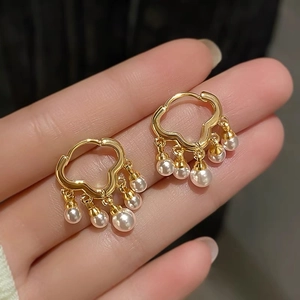 Elegant gold cloud-shaped earrings with cascading white pearls for a sophisticated look