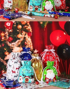 Detail of assorted Christmas drawstring gift bags with shiny metallic snowflake patterns