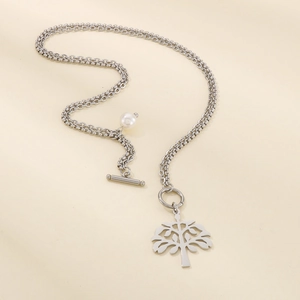 Detail of silver tree of life pendant with white pearl charm and OT toggle clasp necklace
