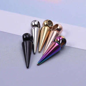 Macro shot of tapered stainless steel ear stretchers in black, silver, gold, and rainbow colors