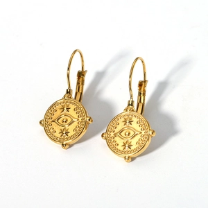 Detailed shot of gold-plated evil eye earrings with star engravings and bead details