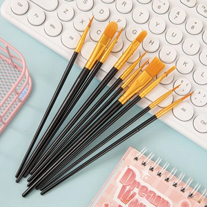 Macro detail of 10-piece brush set with orange nylon bristles and black long handles