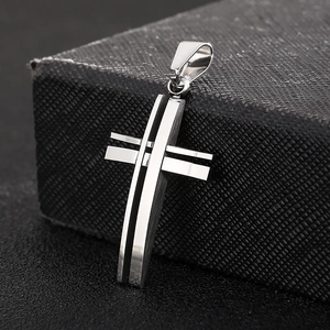 Macro shot of silver-toned hollow double-layered stainless steel cross pendant