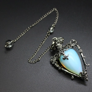 Detailed macro shot of vintage silver flower frame with a blue opal stone pendant
