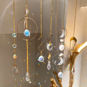 Modern suncatcher set with gold geometric frames and crystal prisms reflecting rainbow light