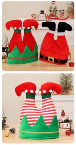 Detailed view of plush elf and Santa leg hats with bells for festive Christmas parties