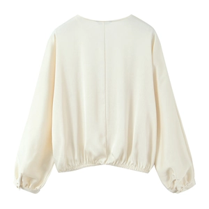 Back view of cream satin long sleeve shirt with elastic waist and silk-like finish