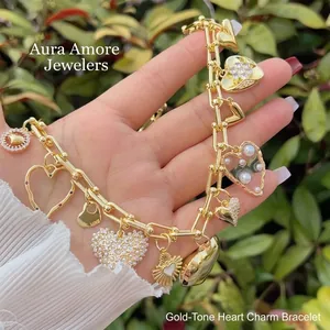 18k gold plated chain bracelet with CZ heart charms and pearl detail on a natural background
