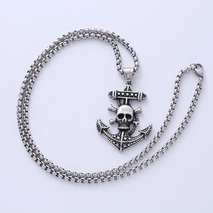 Silver punk pirate anchor necklace with skull pendant on light blue surface