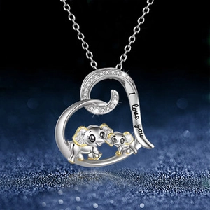 Detail of silver heart necklace with 'I love you' engraving and two elephant charms