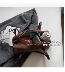 Interior view of brown suede Boston bag showing spacious storage for daily essentials