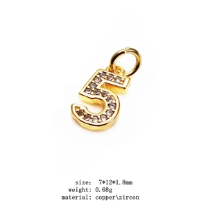 Macro detail of 14K gold plated number 5 pendant with cubic zirconia and size specs
