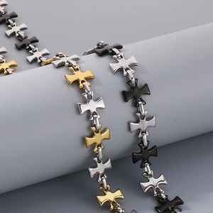 Detail of cross-linked chain bracelets in gold, silver, and black metallic finish