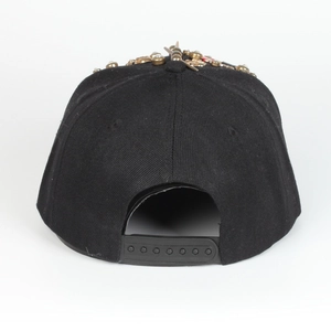 Detail of snapback closure and vintage metallic studs on a black hip-hop baseball cap