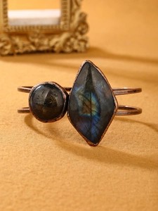 Detail of vintage bronze cuff bracelet with blue labradorite and amazonite gemstones