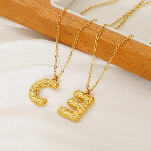 Lava textured 18K gold-plated stainless steel initial necklace with letters C and E