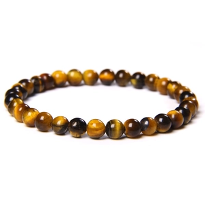 Close-up of natural tiger eye stone beads showing cat-eye effect and wood-like texture