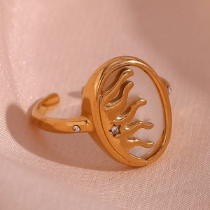 Detail of 18K gold plated ring with white shell inlay and sparkling sun star carving