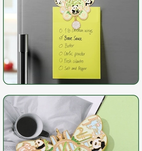 Detail of Panda metal fridge magnet with enamel finish and pink lotus pendant attached to fridge