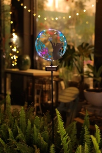 Detailed close-up of solar garden light featuring colorful stained glass cat and butterfly