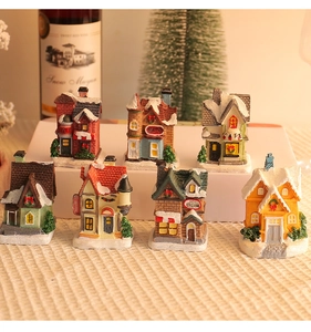 Set of 7 miniature resin Christmas houses with snow-covered rooftops for holiday decor