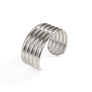 Close-up of ribbed texture on a polished silver cuff bracelet with reflective finish