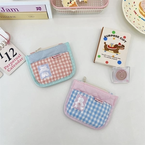 Detail of quilted cotton coin purse with transparent card slot and zipper closure