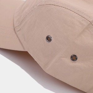Close-up of metal ventilation eyelets and precise stitching on the quick-dry baseball cap