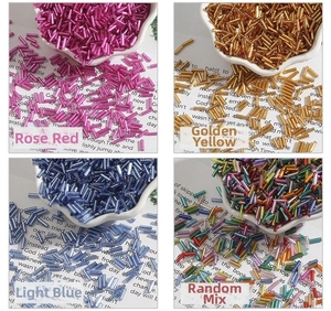 Macro detail of 2x7mm bugle beads in assorted metallic colors for DIY jewelry crafting