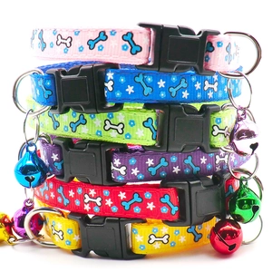 Close-up of nylon pet collars with bone patterns and colorful bells in six vibrant colors