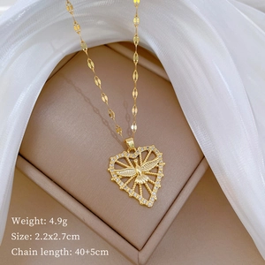 Detail of gold heart necklace with bird motif and rhinestones including size specs