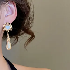 Elegant vintage heart stud earrings with water drop pearls and gold metal finish