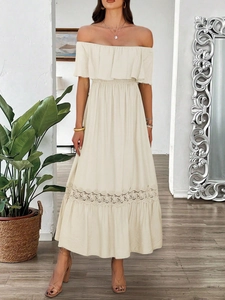 Detail view of beige off-shoulder maxi dress with ruffled waist and delicate lace stitching