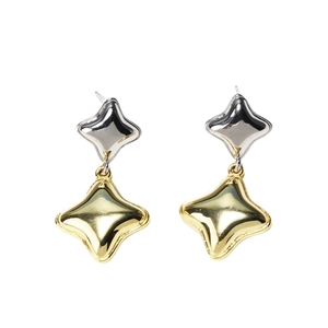 Elegant gold and silver star earrings in modern geometric minimalist design on white background