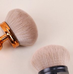 Close-up of high-density mushroom powder brushes with soft bristles and metallic handles