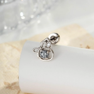 Star-shaped silver cartilage piercing earring with grey zircon stones on a white stand