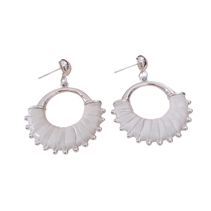 Vintage silver earrings with circular leather fan pendants and white textured accents